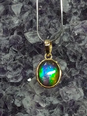 14k Gold Ammolite pendant stunning and dainty purple, blue, green and yellow.