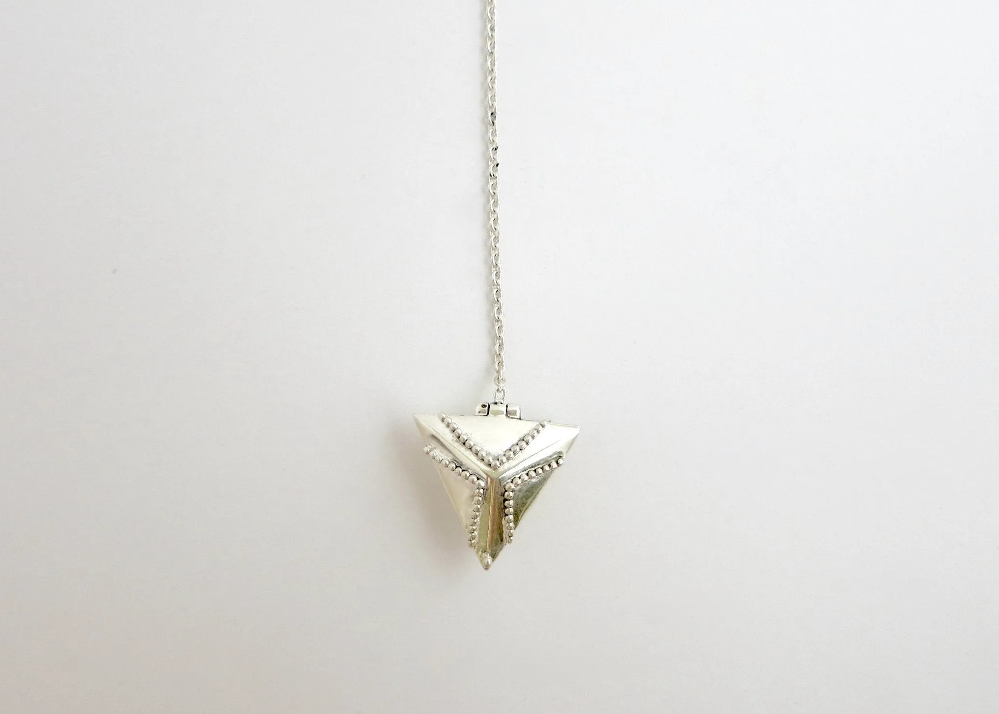 Elegant, vintage-inspired, sterling silver lariat necklace with a triangular granulation-work locket