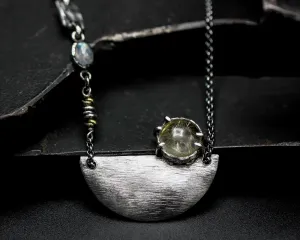 Rutilated quartz cabochon pendant necklace with silver plate in semi-oval shape on sterling silver chain